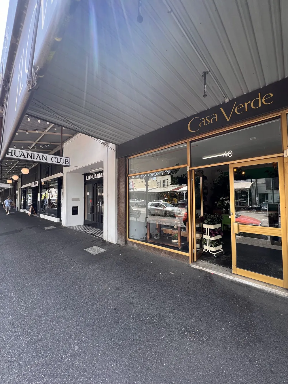 The Casa Verde shopfront under the Errol Street verandah, with gold signage and gold window frames